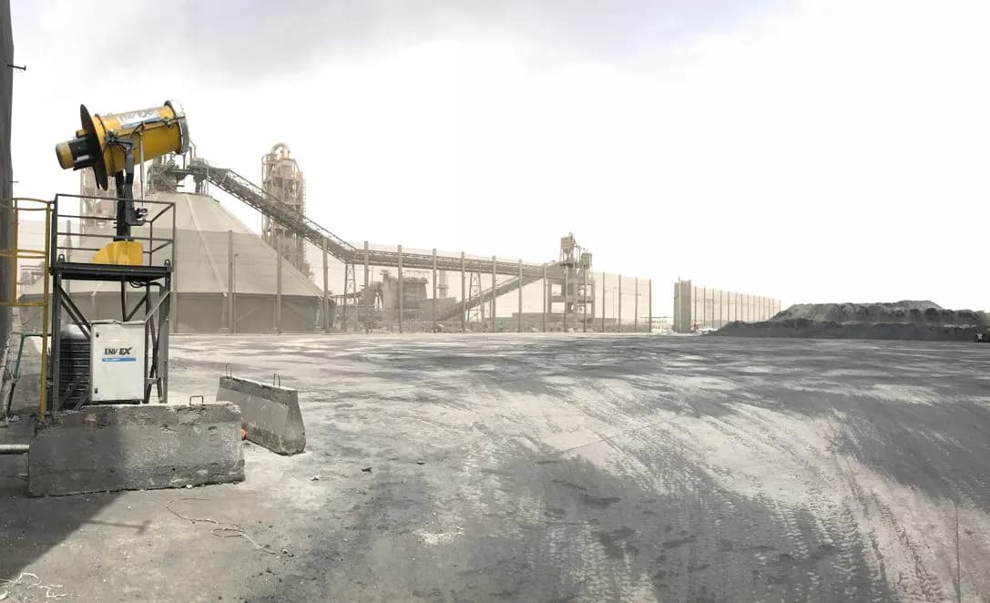 A powerful water mist from a dust cannon suppressing dust clouds at a mine.