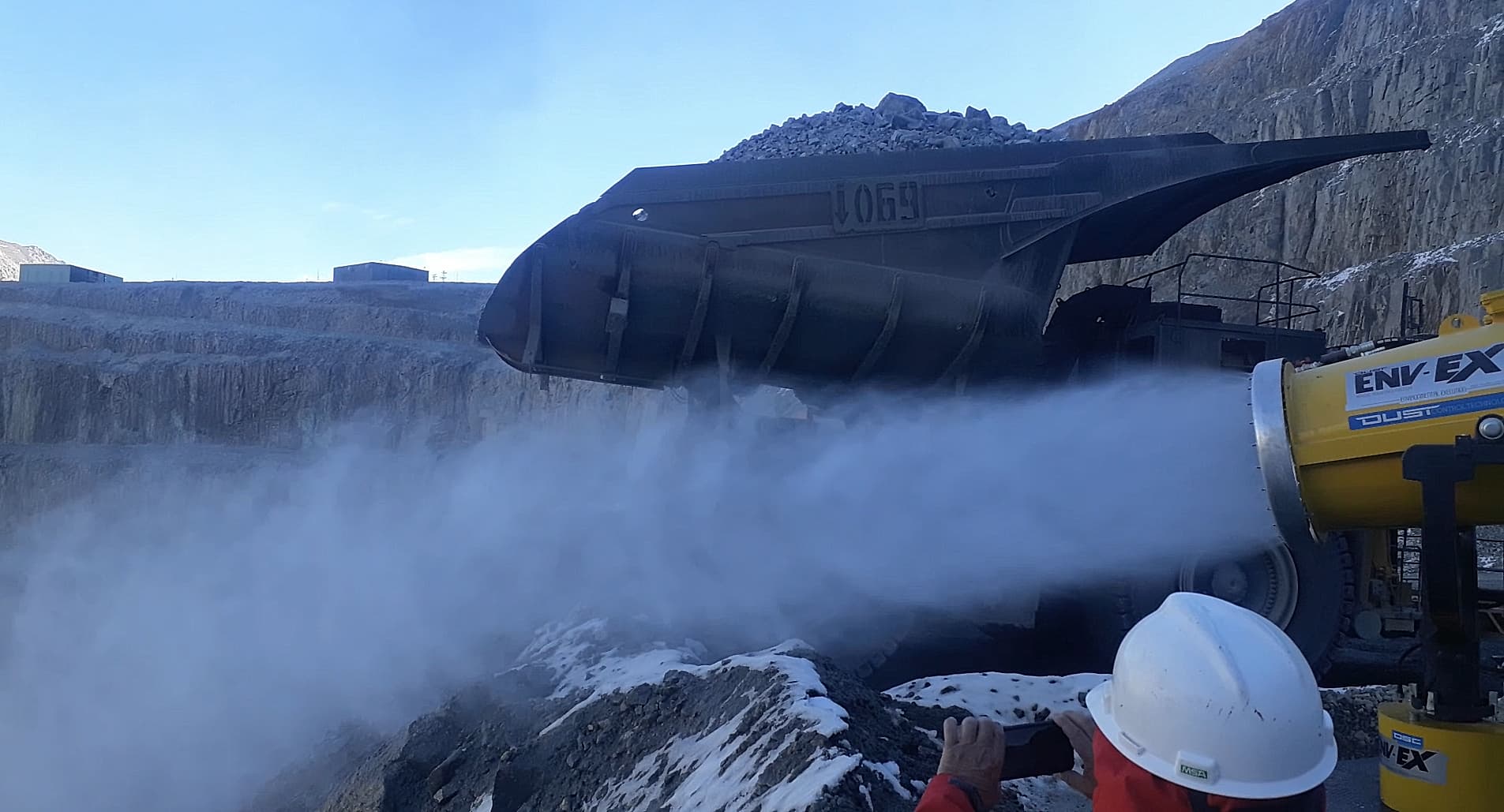 A powerful water mist from a dust cannon suppressing dust clouds at a mine.