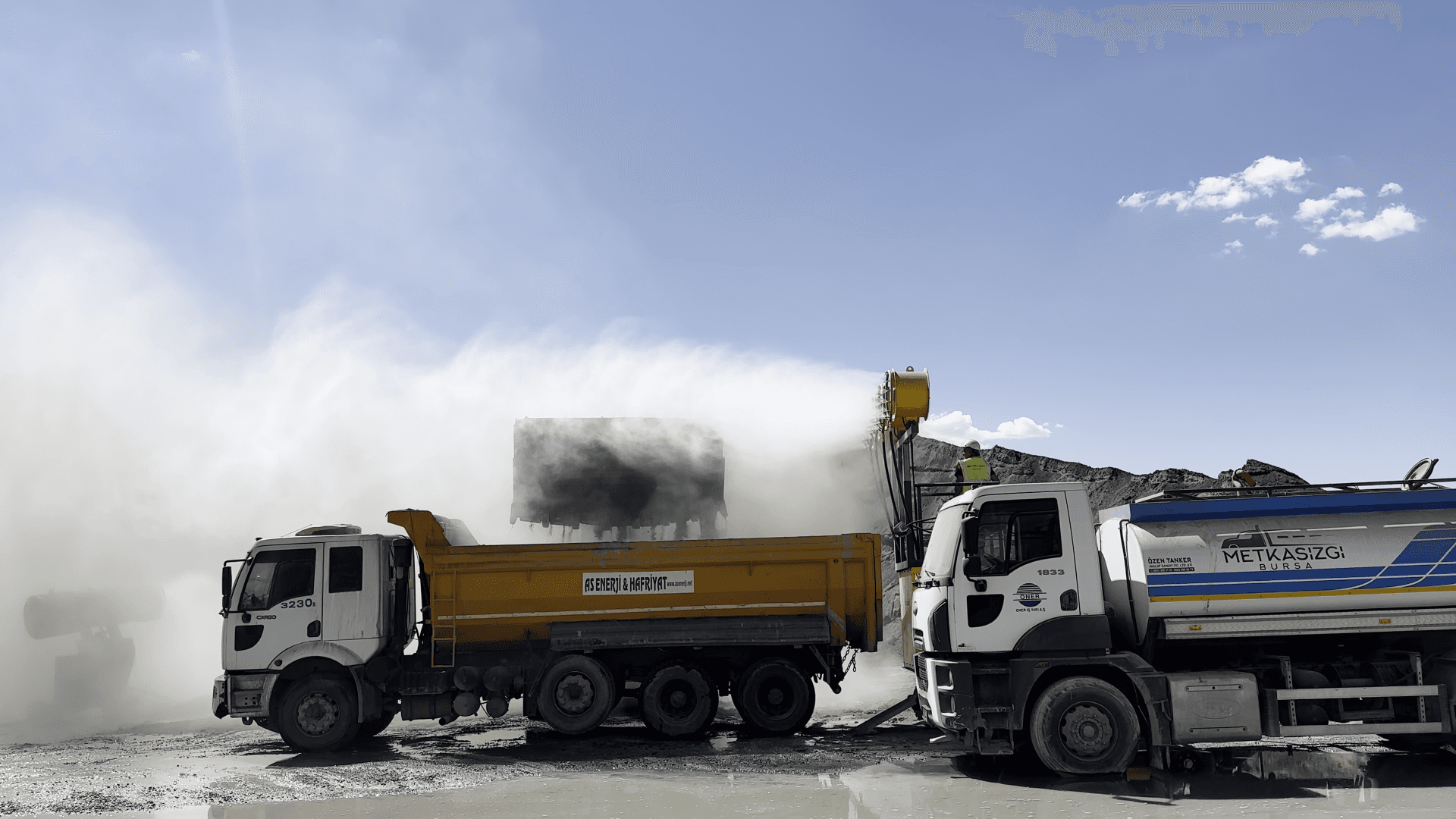 A truck-mounted dust suppression unit working on a haul road.