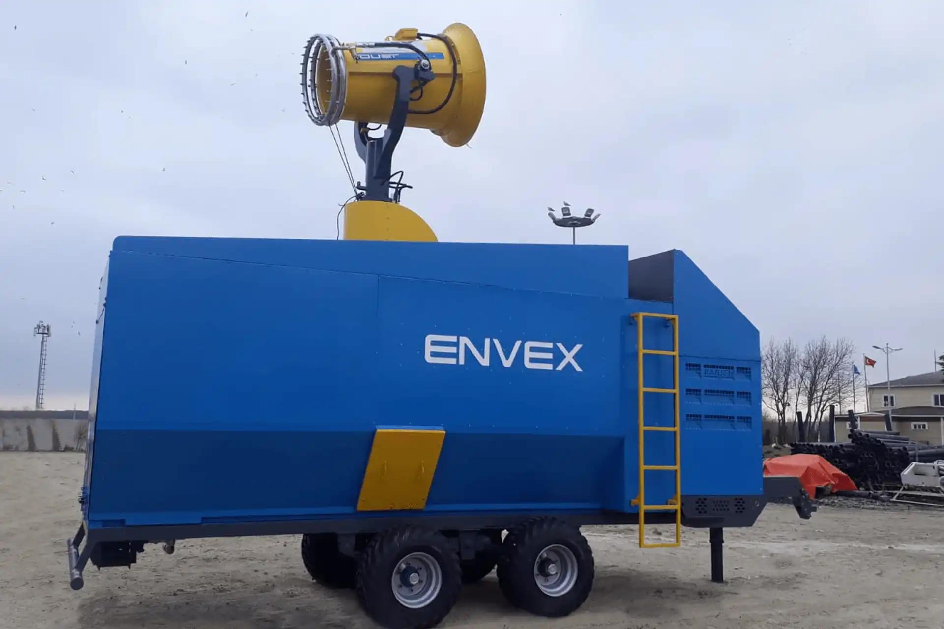 Trailer Mounted Fog Cannon with Water Tank and Generator A blue, trailer-mounted dust suppression unit with an integrated water tank and generator.