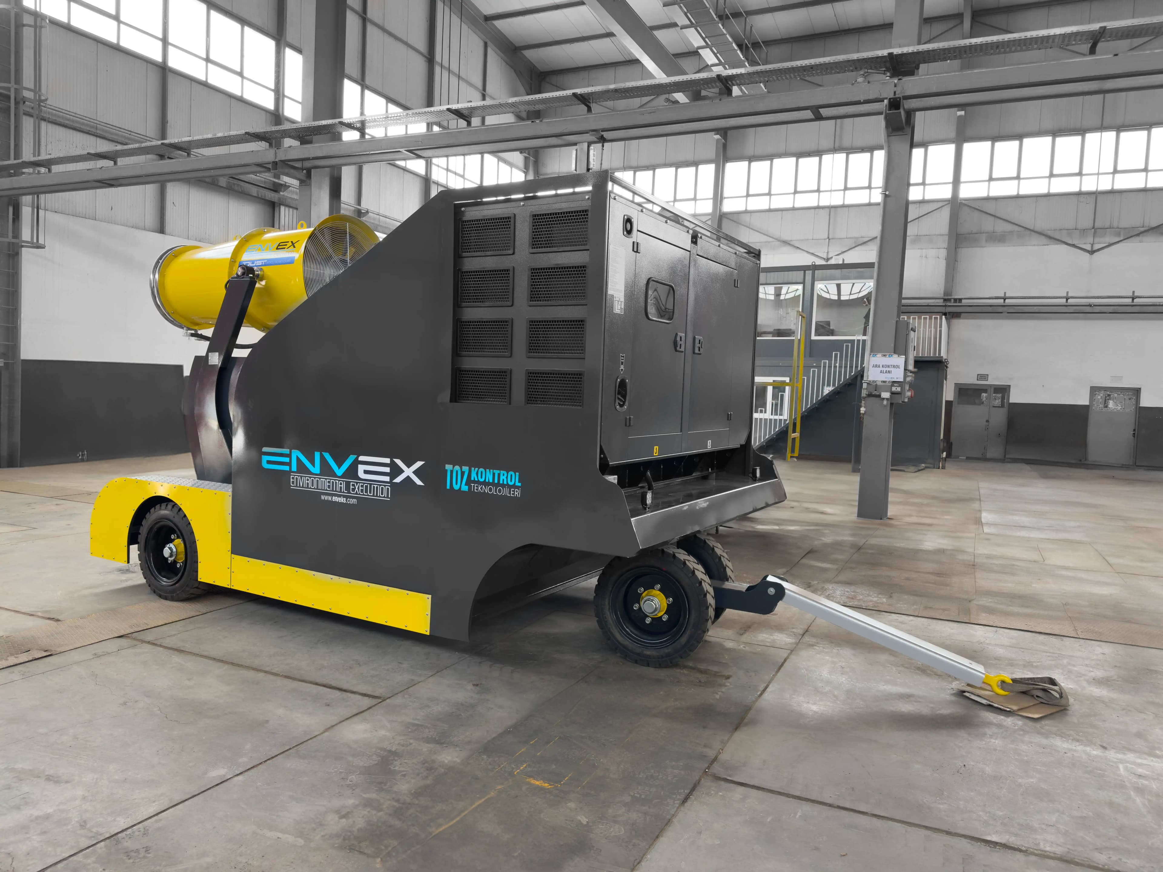 Trailer Mounted Fog Cannon with Water Tank and Generator A mobile dust control system spraying a powerful water mist at a building demolition.